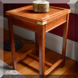 F07. Side table with brass corner braces. 26”h x 14”w 